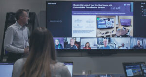 Presenter using Jabra Panacast 50 in a Microsoft Teams Signature Room, with the Front Row experience on a Jupiter Pana monitor